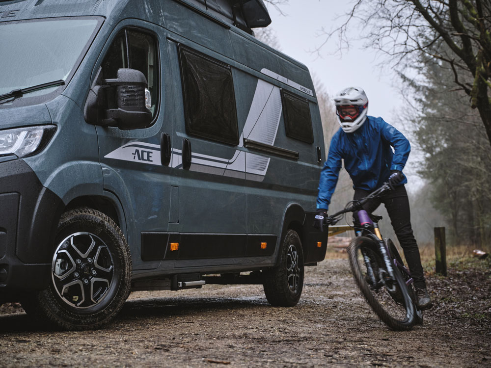 Biker next to off grid campervan